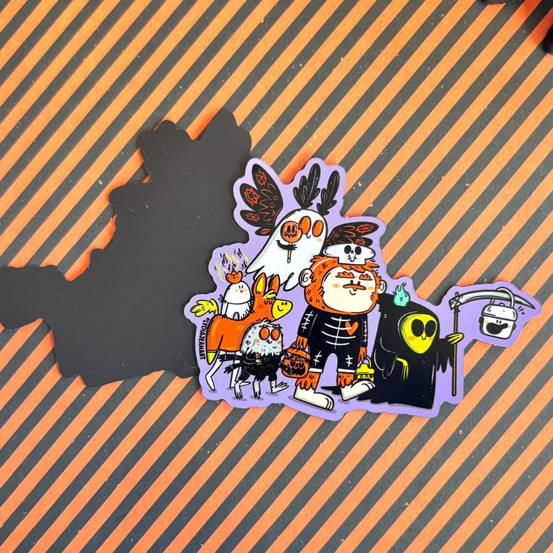 May include: A Halloween-themed sticker featuring a group of cartoon characters, including a ghost, a skeleton, and a grim reaper. The sticker has a purple border and is set against a background of orange and black diagonal stripes.
