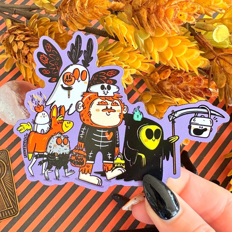 May include: A purple sticker featuring a group of cartoon characters in Halloween costumes. The characters include a ghost, a skeleton, a grim reaper, and other creatures. The sticker has a black and orange striped background.