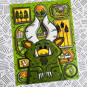 May include: A green monster with large teeth and horns is surrounded by small framed pictures. The pictures depict scenes of nature, including trees, a cabin, and a campfire.