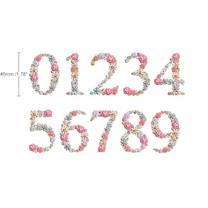 Puede incluir: Diseño de bordado floral de los números del 0 al 9. Cada número está formado por flores rosas, azules y blancas. El diseño tiene aproximadamente 45 mm de alto.