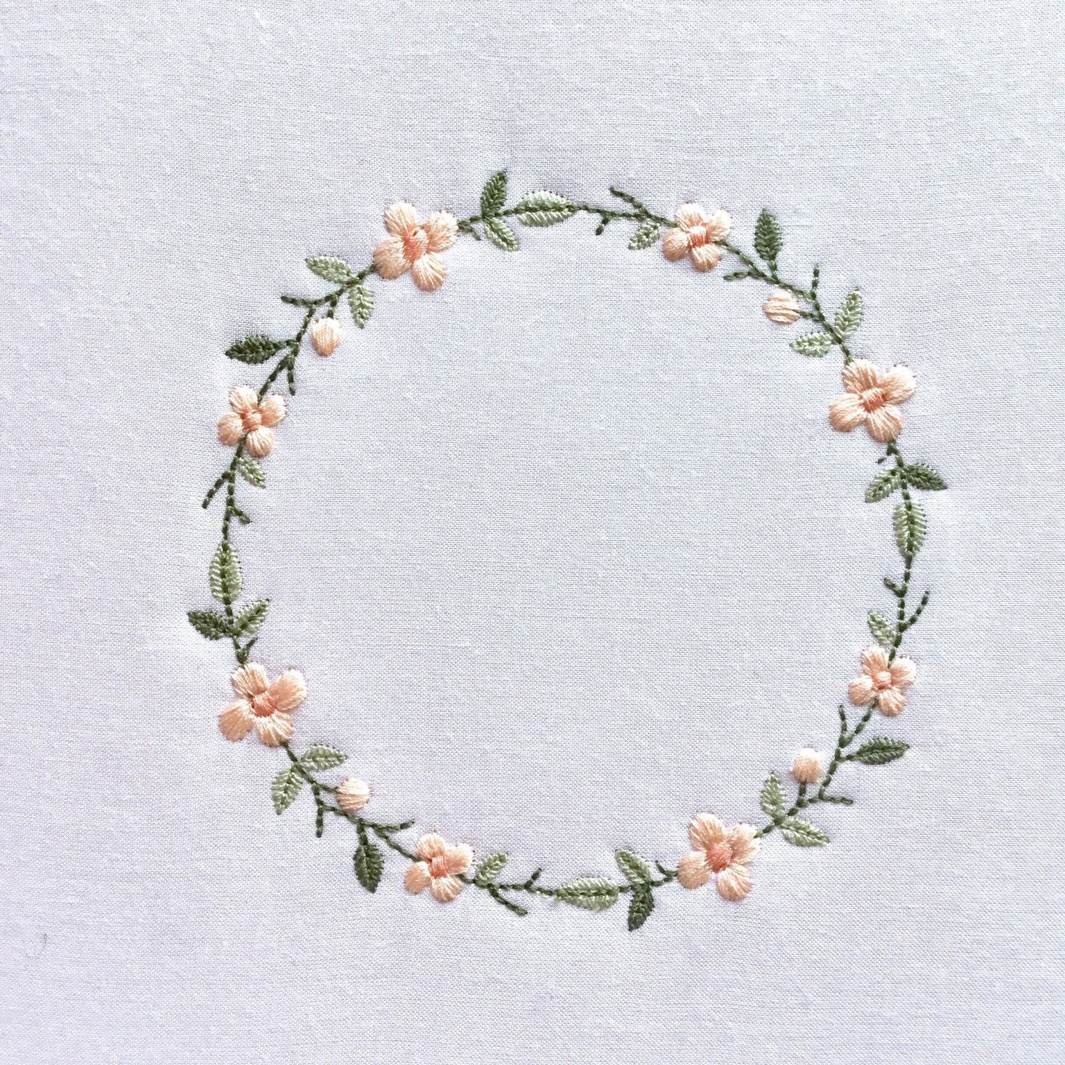 繊細な花のリース刺繍。花の円形ミシン刺繍デザイン。シンプルな花柄