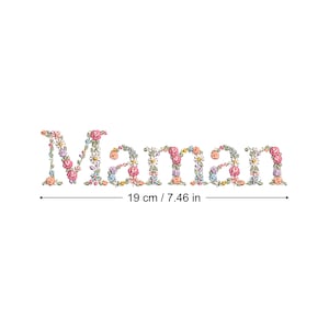May include: Floral embroidery design of the word "Maman" in pink, blue, and green colors. The design measures 7.46 inches wide.