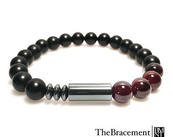 May include: Black onyx and garnet beaded bracelet with a silver hematite tube and spacer beads. TheBracement | BMNT.
