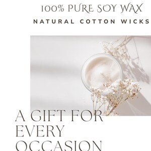 May include: A lit candle in a clear glass jar with a white wax surface. The image includes the text "100% Pure Soy Wax, Natural Cotton Wicks, A Gift For Every Occasion". Dried white flowers are arranged around the candle.