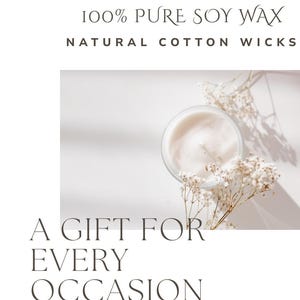 May include: A lit candle in a clear glass jar with a white wax surface. The image includes the text "100% Pure Soy Wax, Natural Cotton Wicks, A Gift For Every Occasion". Dried white flowers are arranged around the candle.