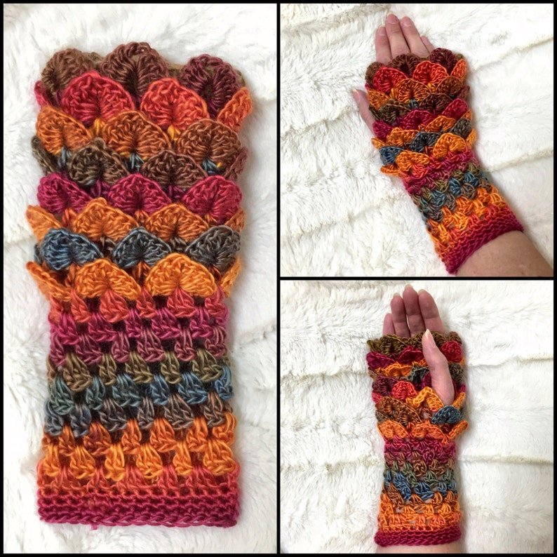 May include: A pair of colorful crocheted fingerless gloves with a scale pattern in shades of orange, brown, red, and blue.