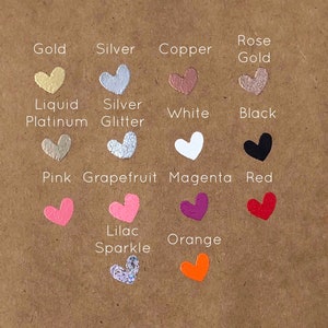 May include: A chart of heart-shaped paint samples with different colours and finishes, including gold, silver, copper, rose gold, liquid platinum, silver glitter, white, black, pink, grapefruit, magenta, red, lilac sparkle, and orange.