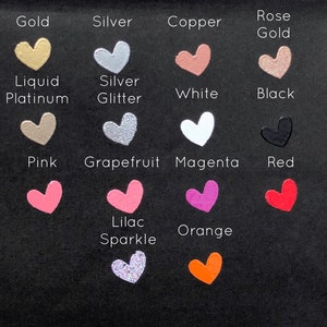 May include: A chart of heart-shaped paint samples in various colors, including gold, silver, copper, rose gold, liquid platinum, silver glitter, white, black, pink, grapefruit, magenta, red, lilac sparkle, and orange.