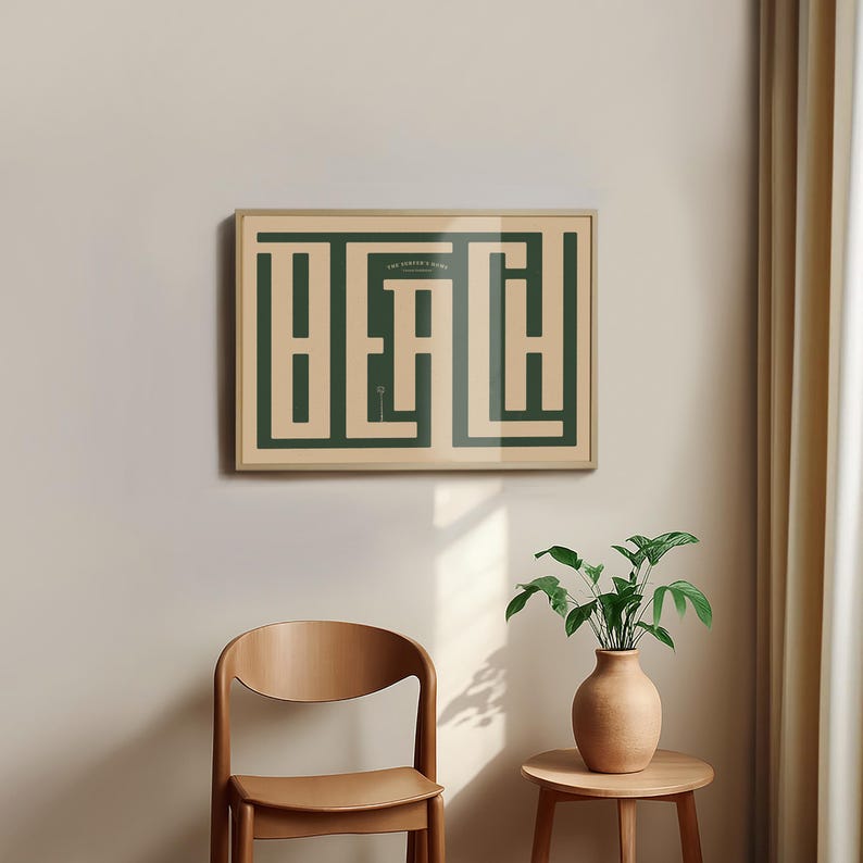 May include: A framed print with a green and beige color scheme. The print features the word "Beach" in a maze-like design. The print is hanging on a white wall.