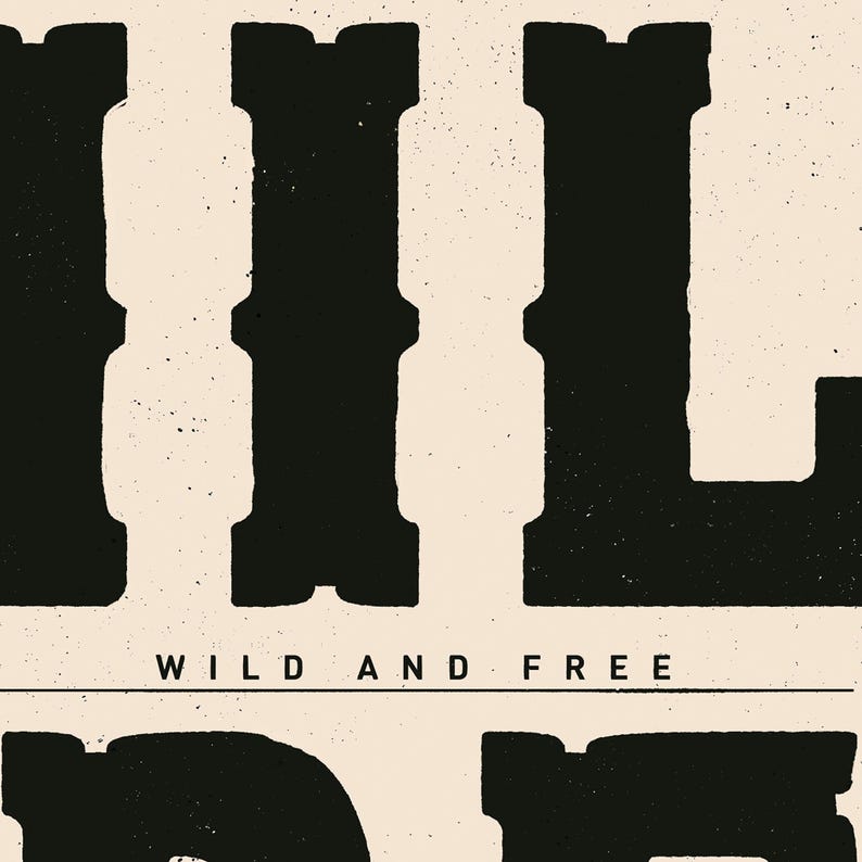May include: Black and white graphic print of the word "WILD" with the text "WILD AND FREE" below it.