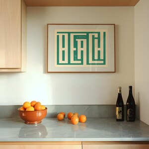 May include: A kitchen counter with a bowl of oranges, two bottles of wine, and a framed print with the word "Beach" in a green geometric design.
