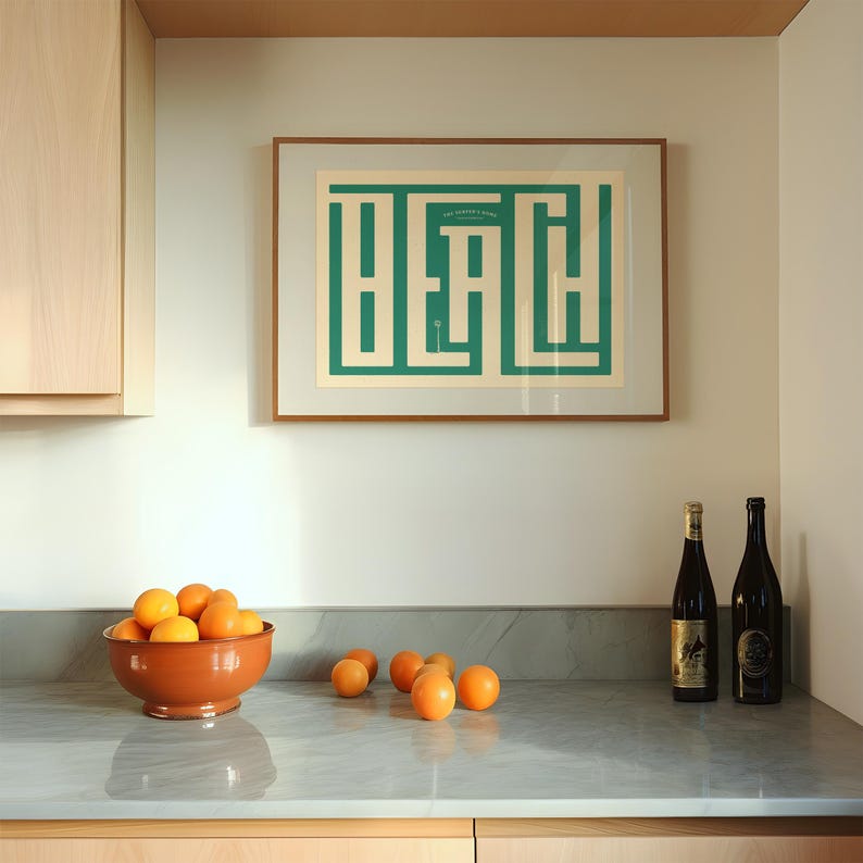 May include: A kitchen counter with a bowl of oranges, two bottles of wine, and a framed print with the word "Beach" in a green geometric design.