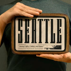 Handcrafted wooden sign of Seattle with retro typography, ideal for rustic and vintage decor.