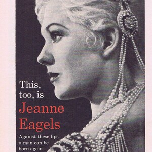 May include: A black and white photo of an actress wearing a pearl necklace and a jeweled crown. The text "Jeanne Eagels" is written in red cursive. The movie poster is for the film "Jeanne Eagels" starring Kim Novak and Jeff Chandler.