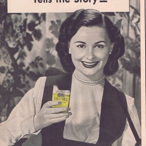 May include: Vintage advertisement for Fatima cigarettes. The image features a woman holding a pack of cigarettes and a tray filled with cigarette packs. Text includes "The Front of my Tray Tells the Story" and "Extra-Mild."