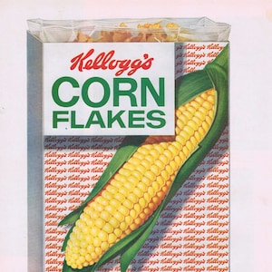 May include: A box of Kellogg's Corn Flakes cereal with a large ear of corn on the front. The box is white with red and green lettering. The text on the box reads "Kellogg's Corn Flakes" and "Fresh from Kellogg's of Battle Creek".
