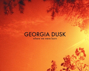 May include: A sunset sky with a bright orange and yellow color scheme. The sky is framed by trees with green leaves. The text "GEORGIA DUSK" is written in black text on the top of the image. Below the text is the phrase "where we were born". The names "DUDGRICK BEVINS" and "LUKE KURTIS" are written in white text on black rectangles in the bottom center of the image.