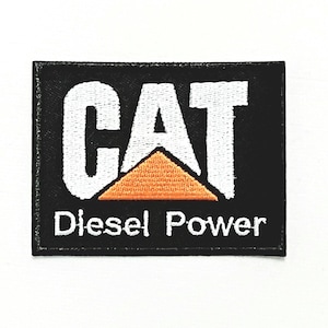 May include: Black and white embroidered patch with the word "CAT" in white and a yellow triangle underneath. The words "Diesel Power" are written in white below the triangle.