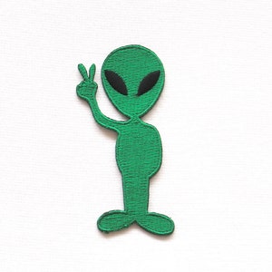 May include: Green alien with black eyes and a peace sign, embroidered patch.