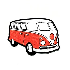 May include: Embroidered patch featuring a red and white vintage van with black accents. The van has a classic design with a rounded front, windows, and wheels. The patch is likely for clothing or accessories.