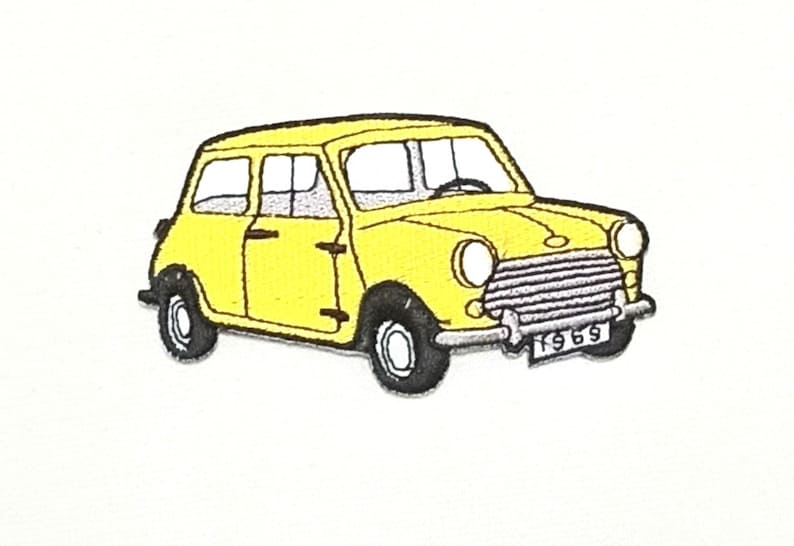 Peut inclure: Une voiture jaune vintage Mini Cooper avec une plaque d'immatriculation noire qui indique "1969".