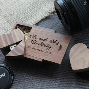 May include: A wooden heart-shaped box with a USB drive inside. The box is engraved with the text "Mr and Mrs Heeley 3rd November 2018".