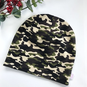 May include: A green, black, and beige camouflage beanie hat.