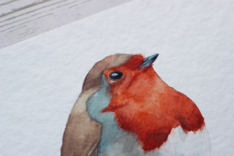 A close up of a watercolour print of a robin