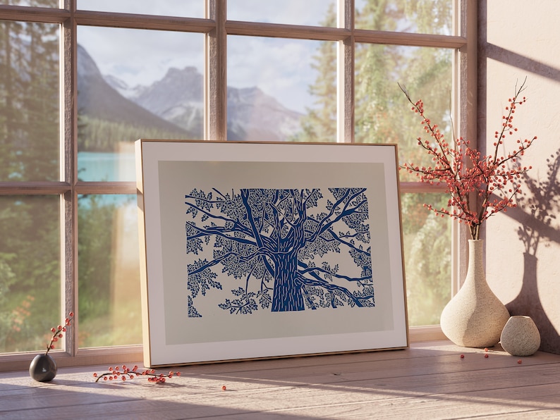 A blue lino print of an oak tree. The perspective is from standing underneath the tree looking up to the top of it.