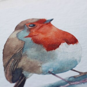 A close up of a watercolour print of a robin