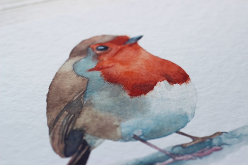 A close up of a watercolour print of a robin