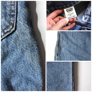 May include: Close-up of blue denim jeans with a Levi's label that reads "Regular 14" and "100% Cotton".