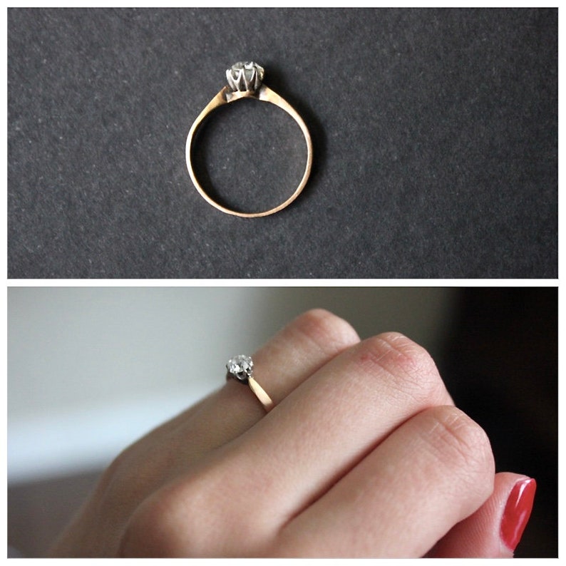 May include: A gold band ring with a single, clear diamond set in a prong setting.
