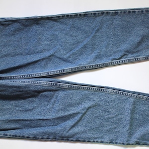 May include: A pair of blue denim jeans with a straight leg and a classic fit.
