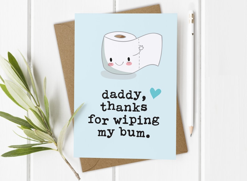 May include: A light blue card with a cartoon toilet paper roll with a smiling face and a heart. The text on the card reads "daddy, thanks for wiping my bum."