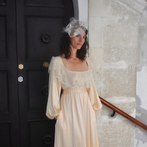 1980's vintage wedding dress with a deep neckline and pockets