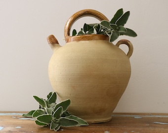 Vintage earthenware jug with yellow varnished