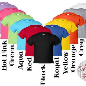 May include: A variety of colors of t-shirts, including lavender, hot pink, green, aqua, red, black, royal blue, yellow, orange, grey, and white. The shirts are all short-sleeved and have a crew neck.