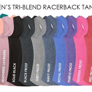 May include: A row of 15 racerback tank tops in various colors, including white, teal, dusty peach, lavender, black, grey, navy, royal blue, purple, fuchsia, red, and turquoise. The tops are made of a tri-blend fabric and have a racerback design.