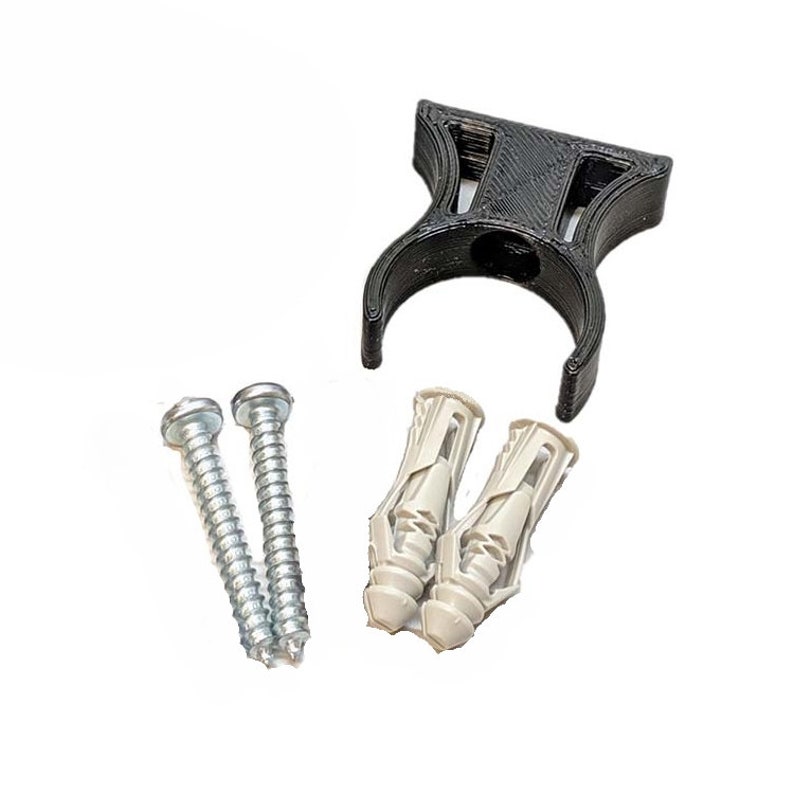 May include: A black plastic wall mount with two screws and two plastic anchors. The wall mount is designed to hold a pipe or other round object.