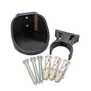 May include: A black plastic wall mount with a curved design and two screw holes. The mount comes with four screws and four plastic anchors.