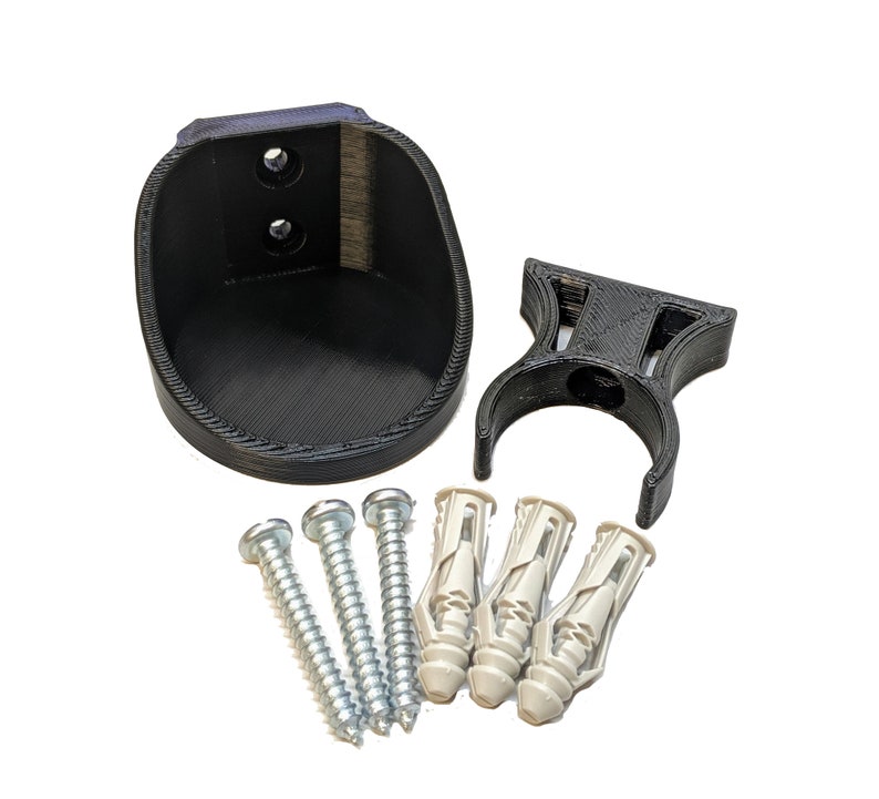 May include: A black plastic wall mount with a curved design and two screw holes. The mount comes with four screws and four plastic anchors.