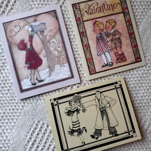 May include: Three vintage Valentine's Day cards with illustrations of couples. The first card features a girl in a red dress and a white hat, standing by a mailbox. The second card features a boy and girl in vintage clothing, standing next to each other. The third card features a couple dancing, with the man holding a bouquet of flowers.