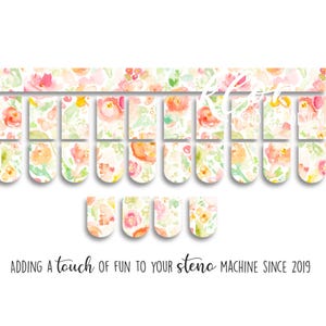 May include: Floral steno machine stickers in a watercolor style. The stickers feature a pattern of pink, orange, and yellow flowers with green leaves. The text "Adding a touch of fun to your steno machine since 2019" is at the bottom.