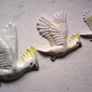 Wall hanging flying birds. Crackle of Cockatoos plaque.