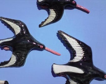 A Squadron of Oystercatchers plaque. Ceramic wall hanging flying birds.