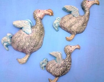 Ceramic wall hanging flying birds. A Dearth of Dodos plaque.