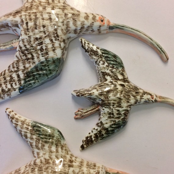 Ceramic wall hanging flying birds. A Herd of Curlews plaque.