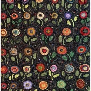 May include: A dark rug with a repeating floral pattern. The flowers are in various colors, including red, orange, yellow, pink, and purple, with green leaves and stems. The background is dark.