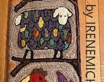 May include: A colorful hooked rug with a bird, sheep, and a rooster on a branch. The rug has a brown background with a yellow sun in the top left corner. The text "hooked by IRENEMICHAUD" is in the right side of the image.